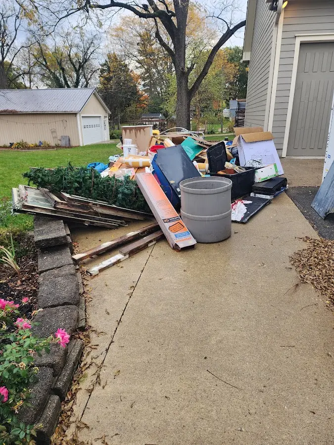 Dumpster being loaded with debris for Commercial Dumpster Rental in Perry Heights